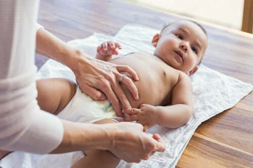 A person changing a baby's diaper.