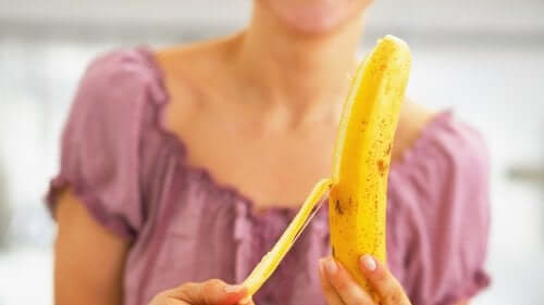 A woman peeling a banana.