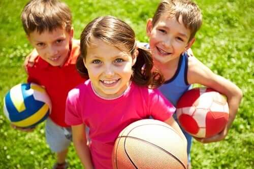 Three children playing with balls.