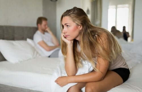 A distant couple in bed.