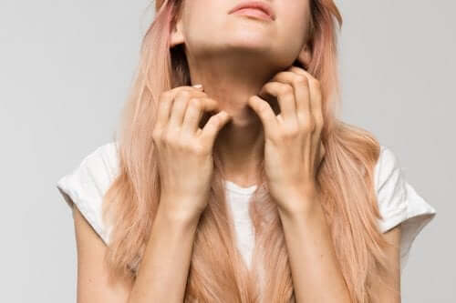 A woman scratching her neck.