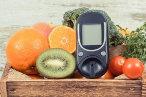 Blood glucose monitor and fruits.