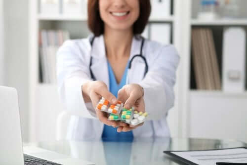 A doctor holding pills.