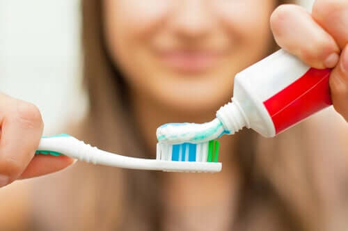 A woman brushing her teeth.