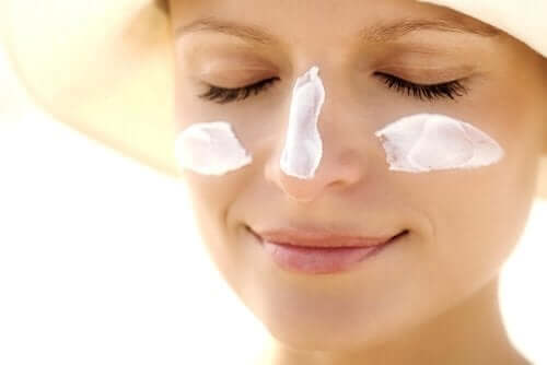 A woman with sunscreen on her face.