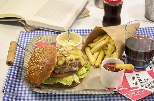 Diet soda cola and hamburger with fries.