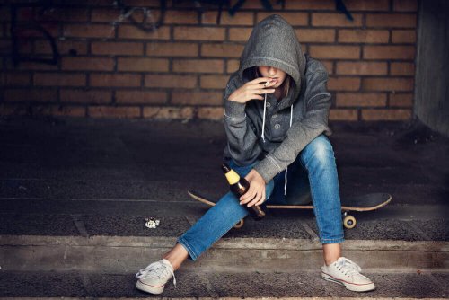A teenager smoking and drinking.