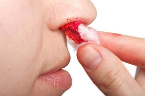 A person removing a nose plug.