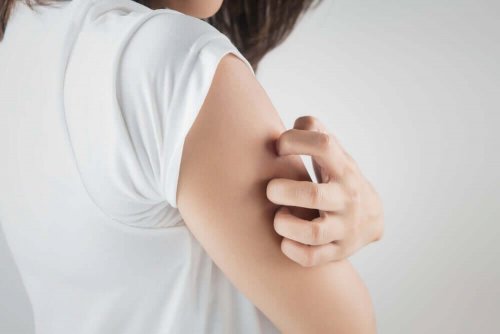 A person scratching their arm.