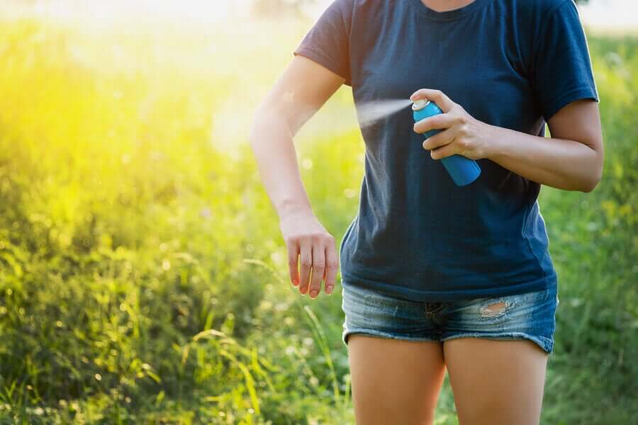 A woman applying insect repellent.