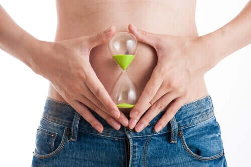 A thin person with an hourglass on their belly.