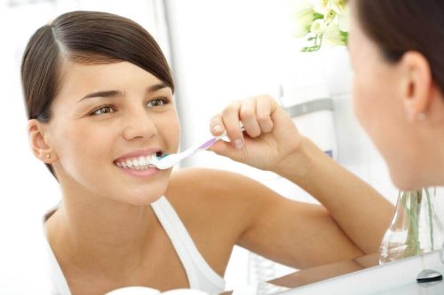 A woman brushing her teeth.
