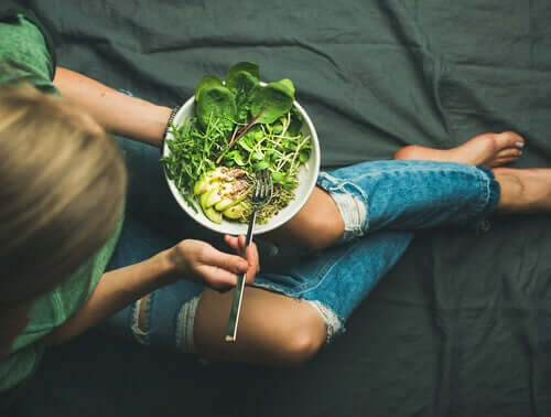 A woman eating a salad.