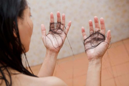 A woman looking at her lost hair.