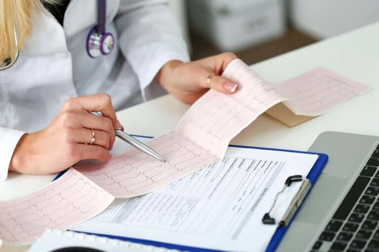 Doctor reviewing an electrocardiogram.