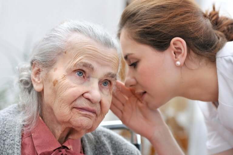 A woman speaking to an elderly lady.