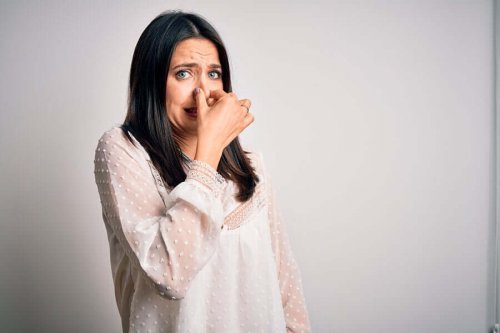 A woman trying to hold her breath.