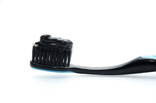 Activated charcoal on a black toothbrush.