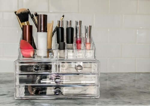 A makeup organizer with makeup and brushes.