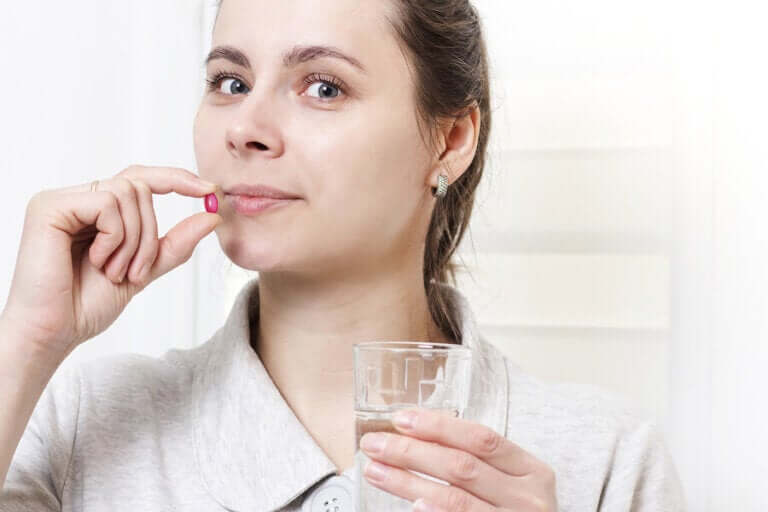 Woman taking a pill.