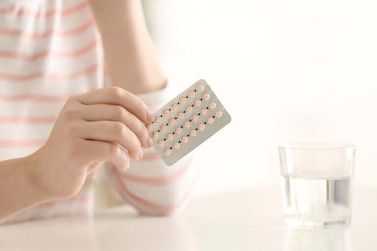 A woman taking birth control pills.