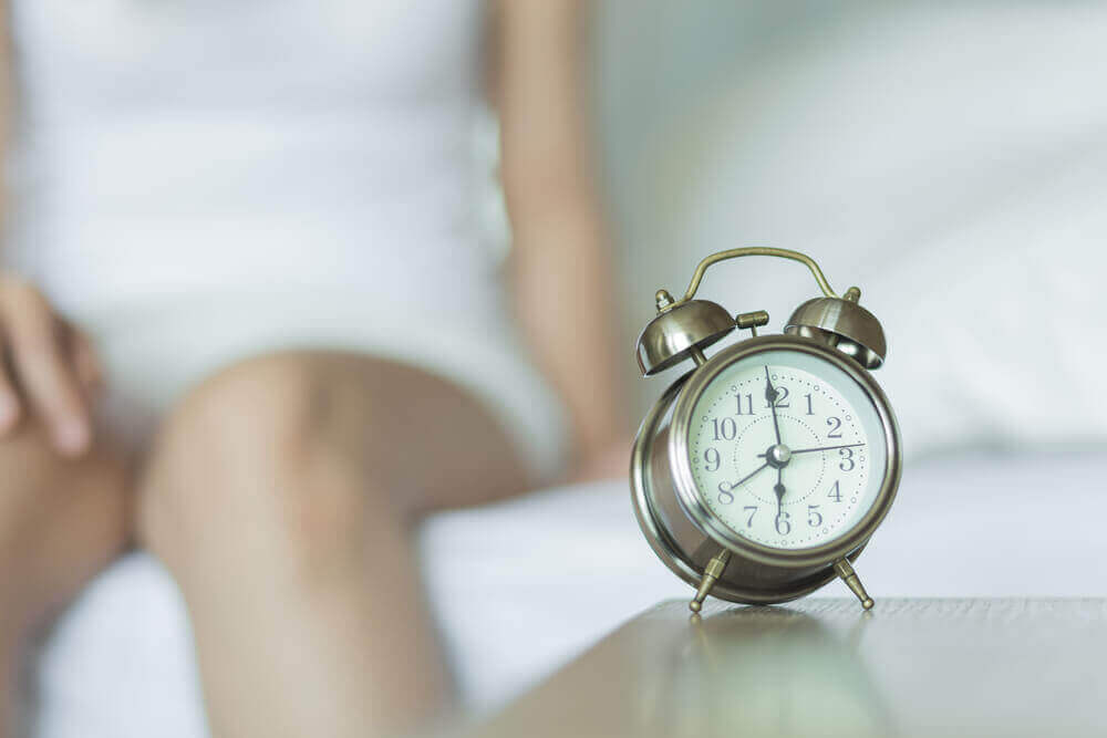 A woman and an alarm clock.