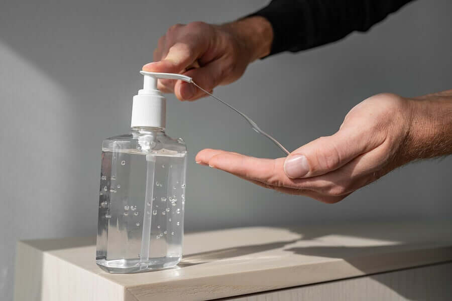 A person applying gel.