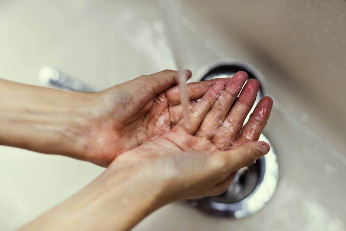 Washing hands with soap and water.