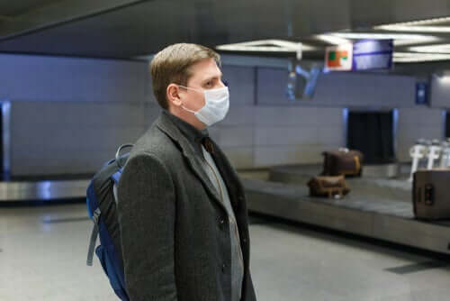 A man using a mask in an airport.