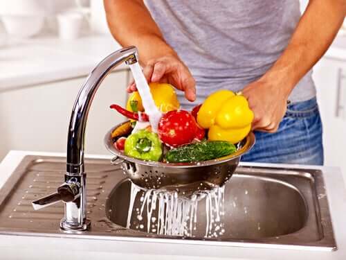 A man washing some vegetables.