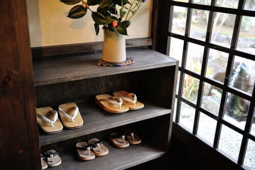 A shoerack at an entrance hall.