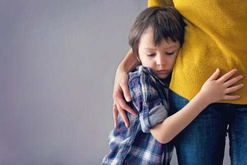 A boy clinging to his mother.