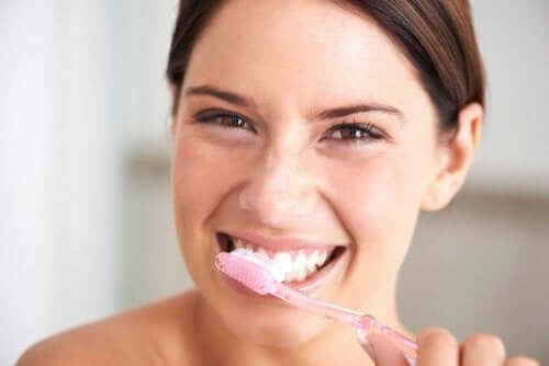 A woman brushing her teeth.