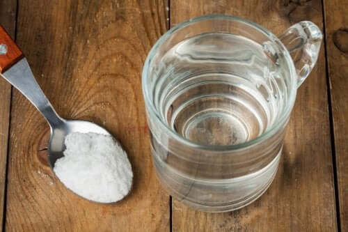 A glass of water and a tablespoon of baking soda.