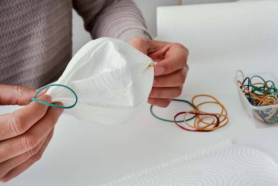 Making a coffee filter face mask.