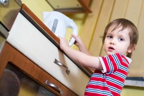 A boy holding a kettle.