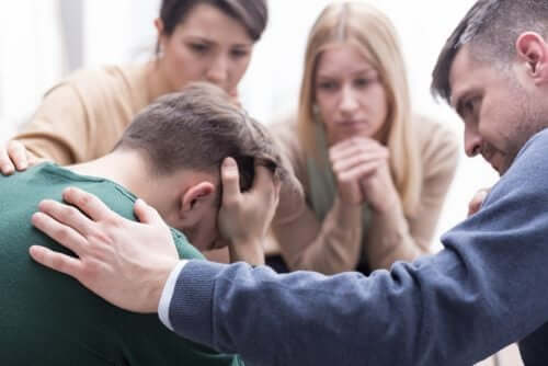 Man getting support from family and friends.