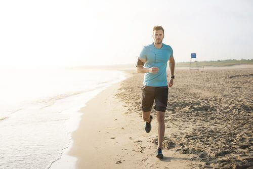A man jogging on the beach.