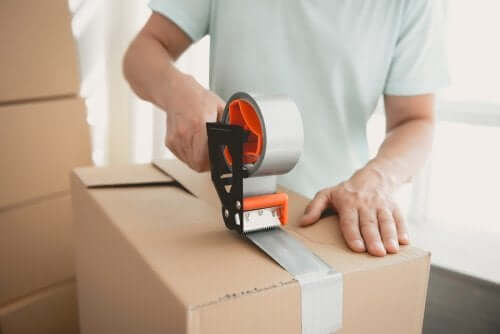 A man storing things in boxes.