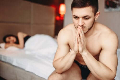 A worried and stressed man in bed.
