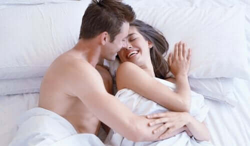 Couple in bed about to have morning sex.