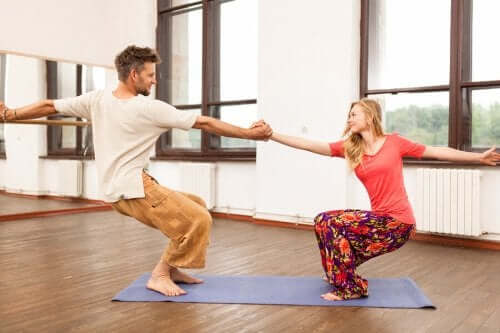 Couple doing Utkatasana.