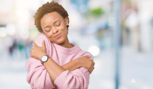 woman hugging herself showing self-love