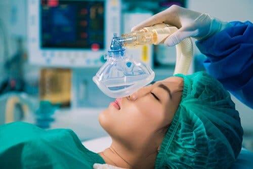 Doctor administering general anesthesia to patient.