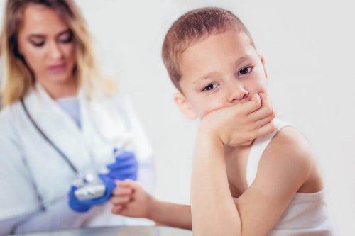 Doctor checking blood glucose levels of a child while he looks away.
