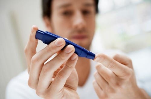 A diabetic man testing blood sugar.