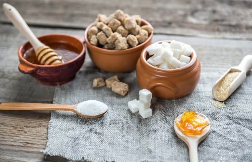 Different types of sugars in bowls and spoons.