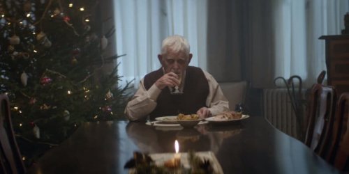 An old man eating alone.