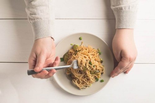 A person eating pasta.