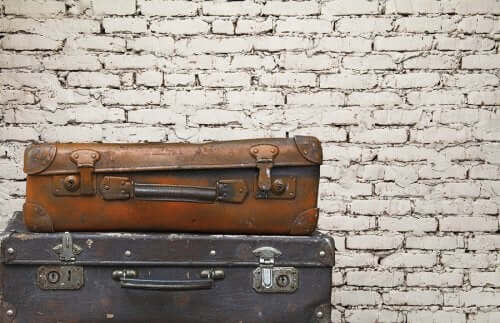 Old suitcases on a brick wall, a great idea for eco-friendly decoration.